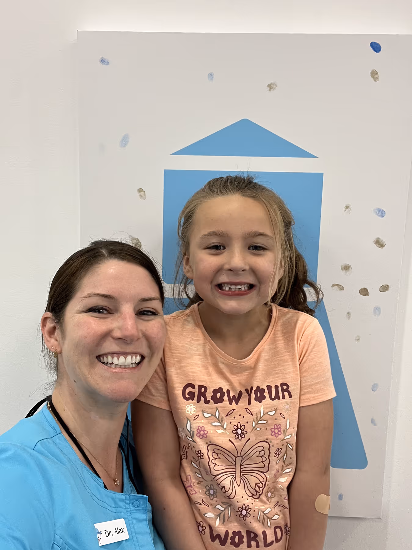 A woman and a little girl posing for a picture.