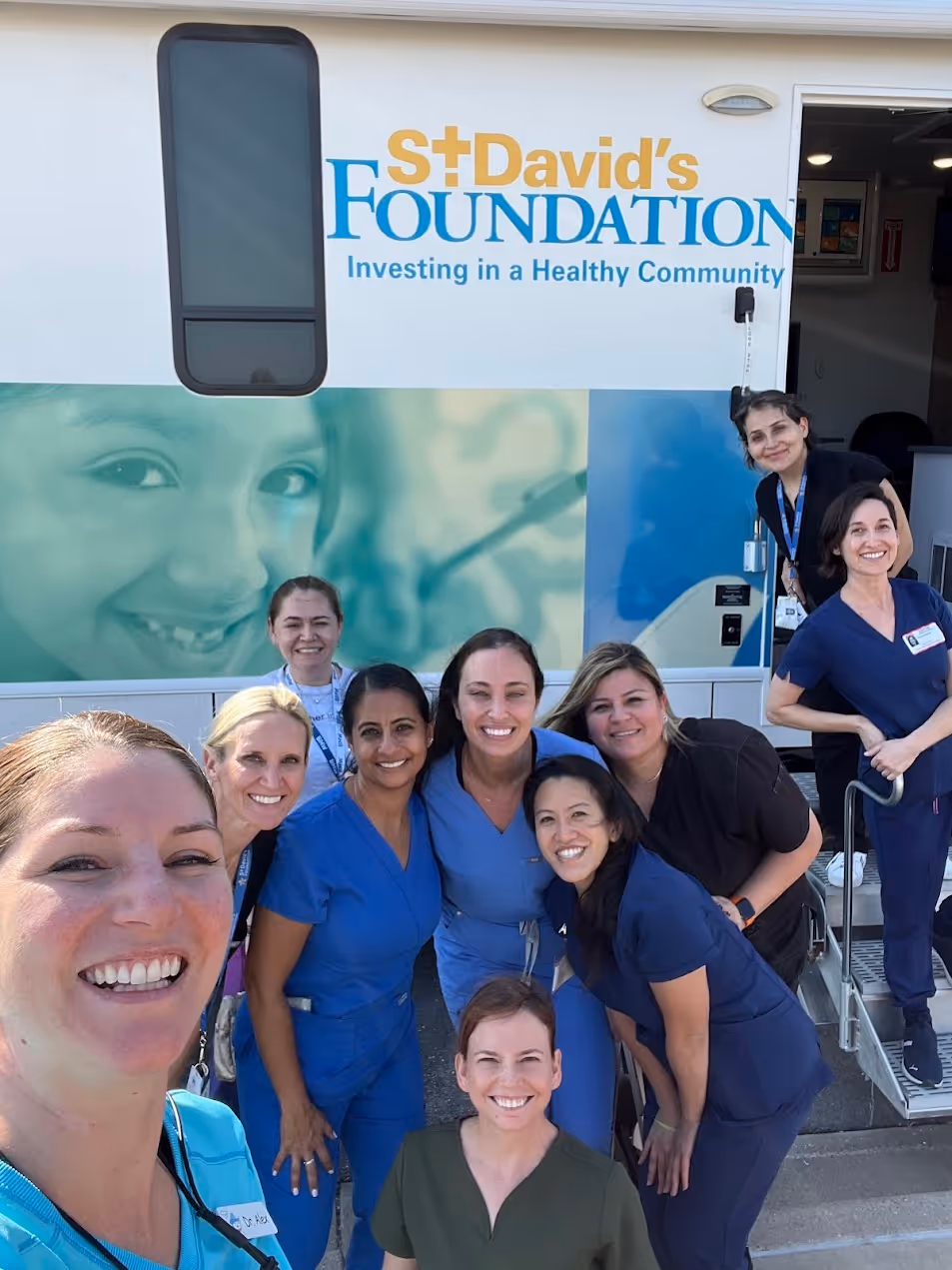 A group of people standing in front of a health center.