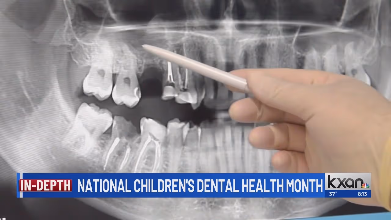 A person holding a pencil in front of a tooth.