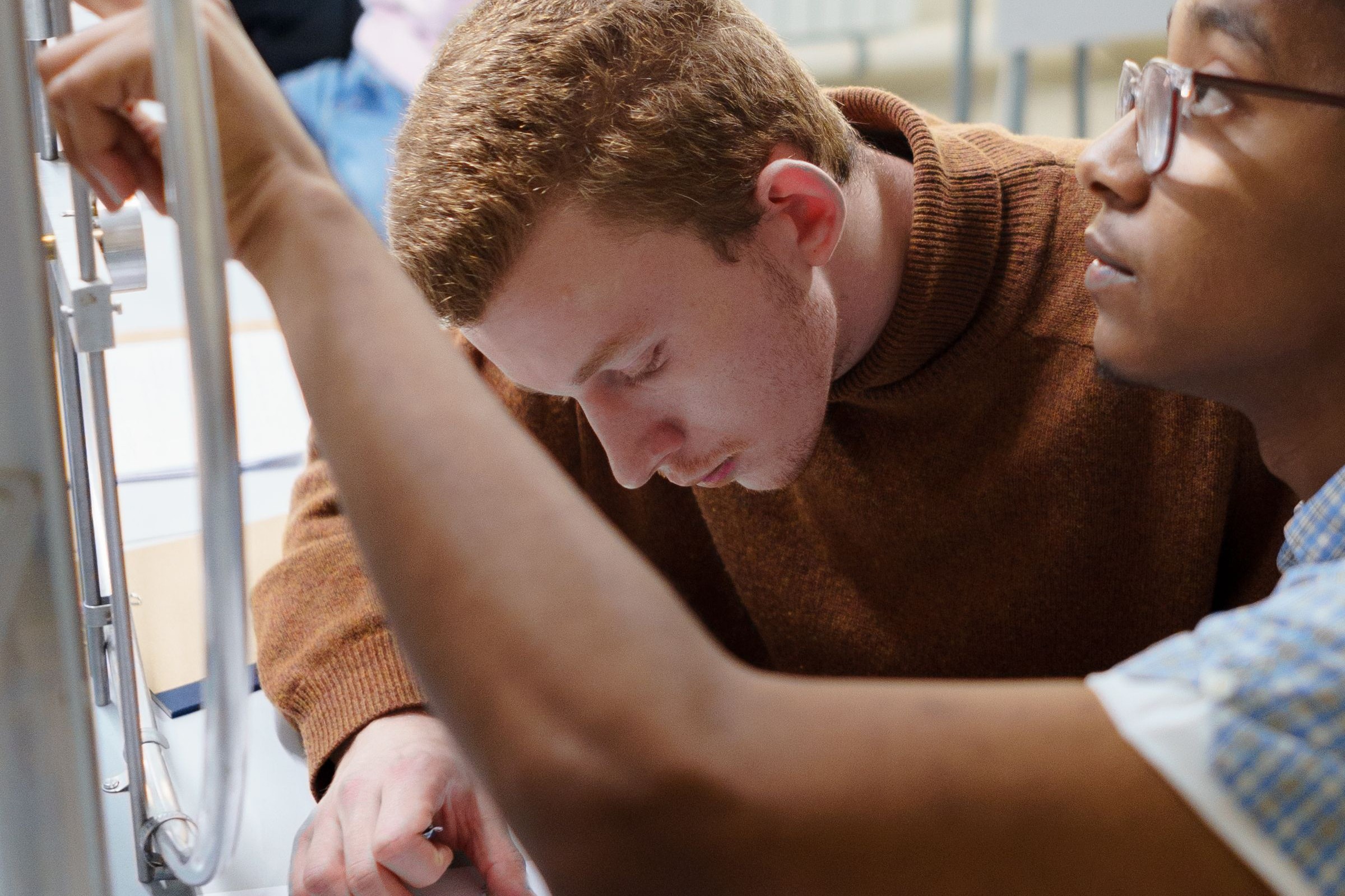 Two students working together at a lab bench