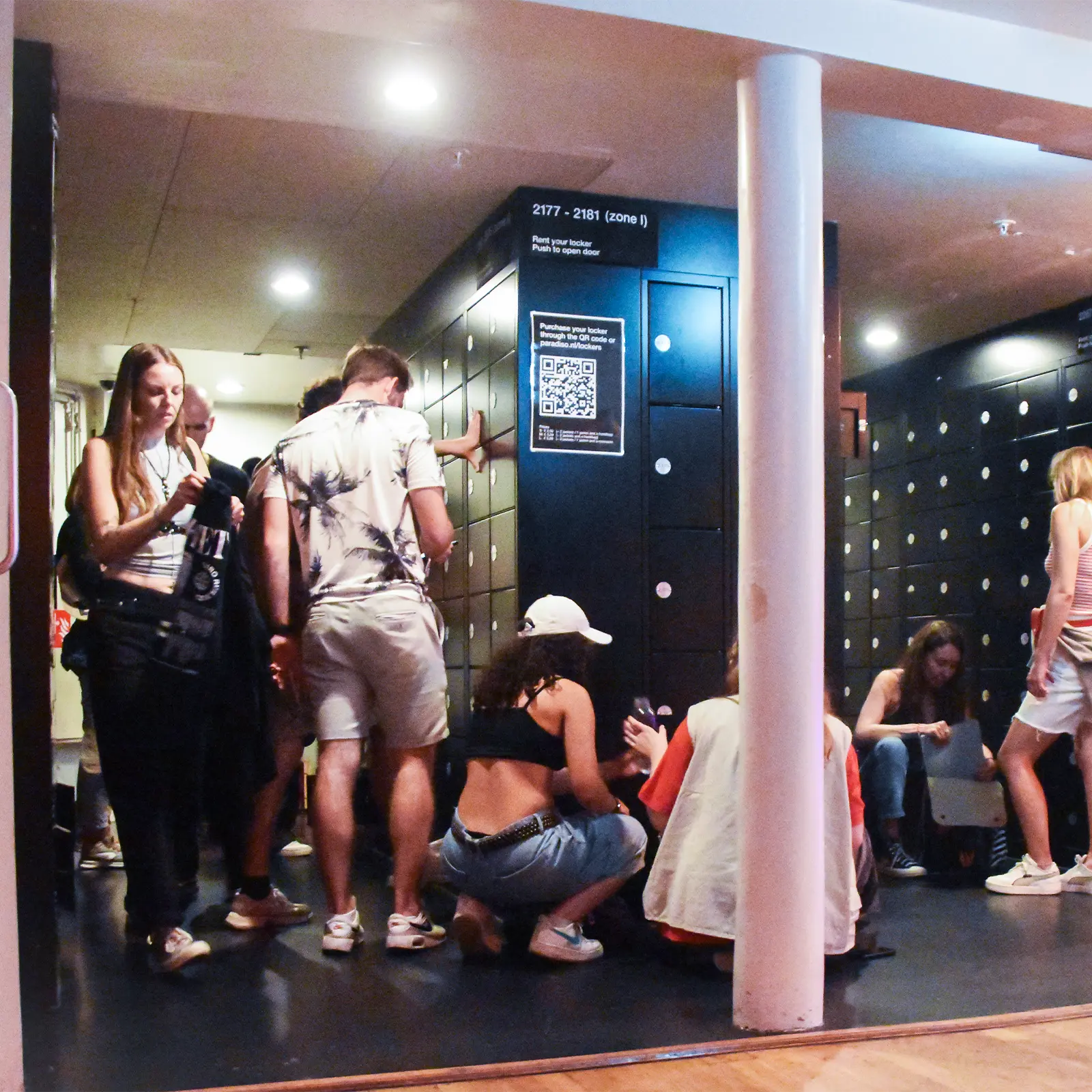 Young people accessing smart lockers at a music hall