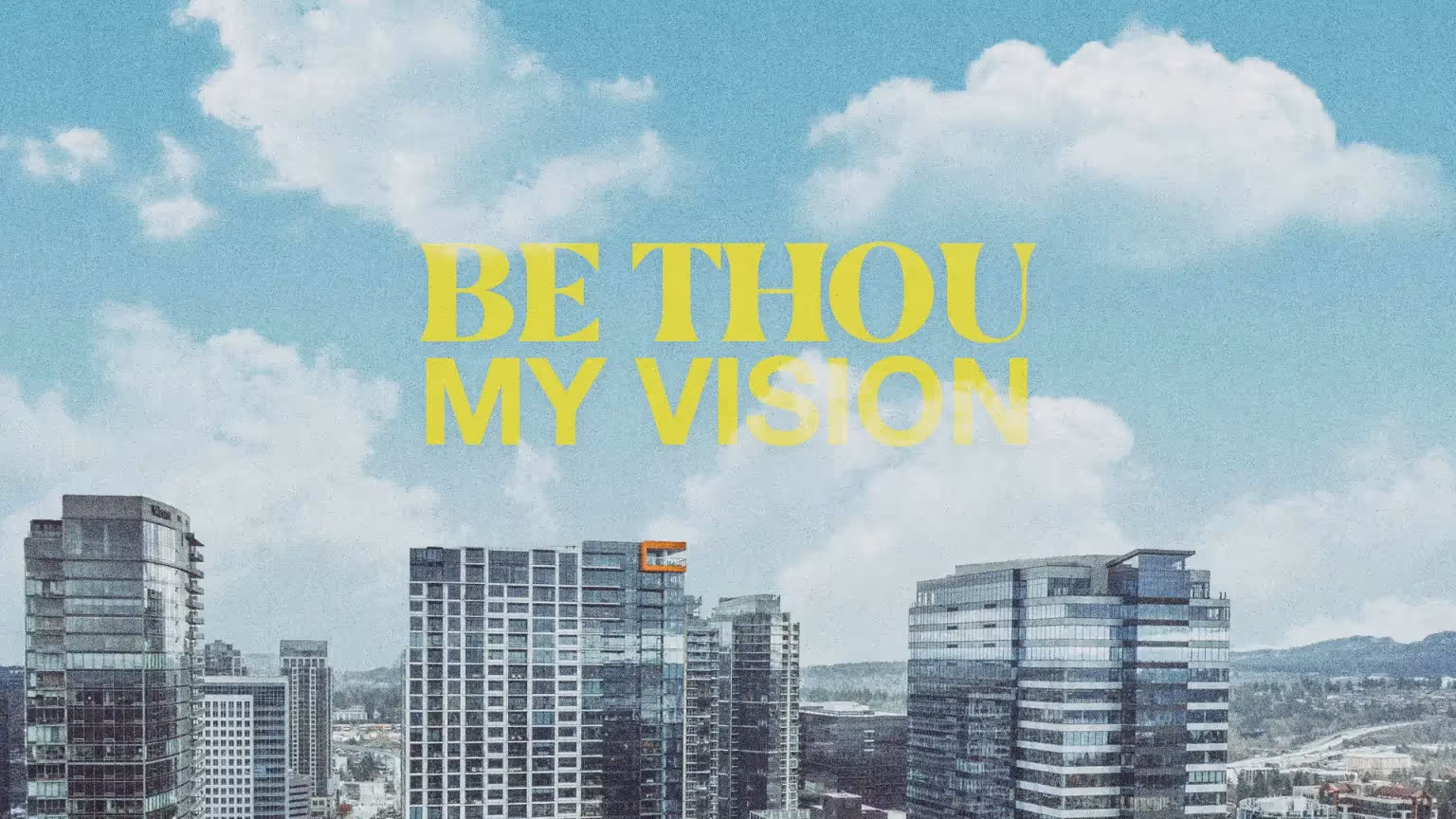 Modern city skyline with inspirational text "Be Thou My Vision".