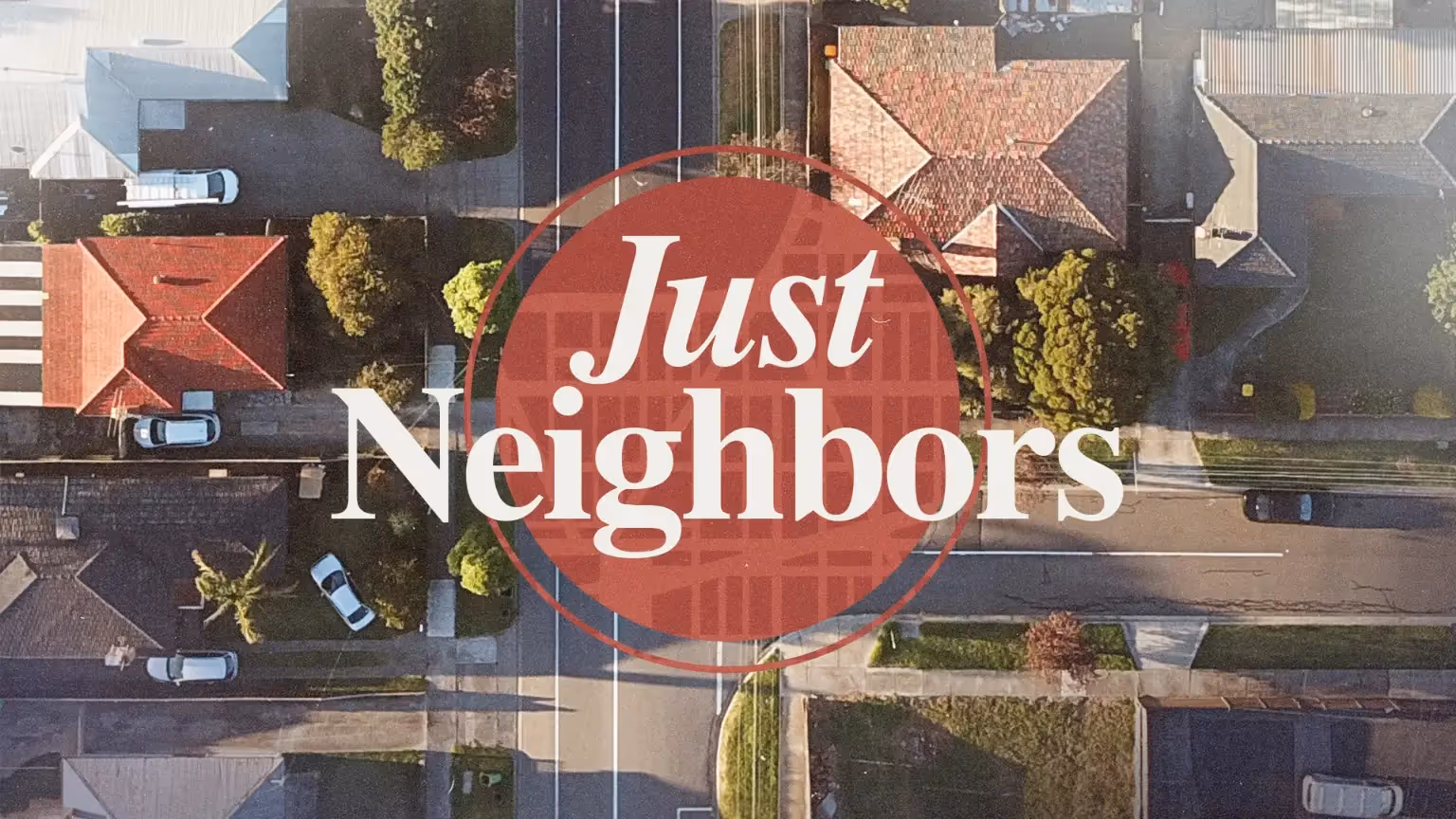 Aerial view of suburban neighborhood with red "Just Neighbors" logo.