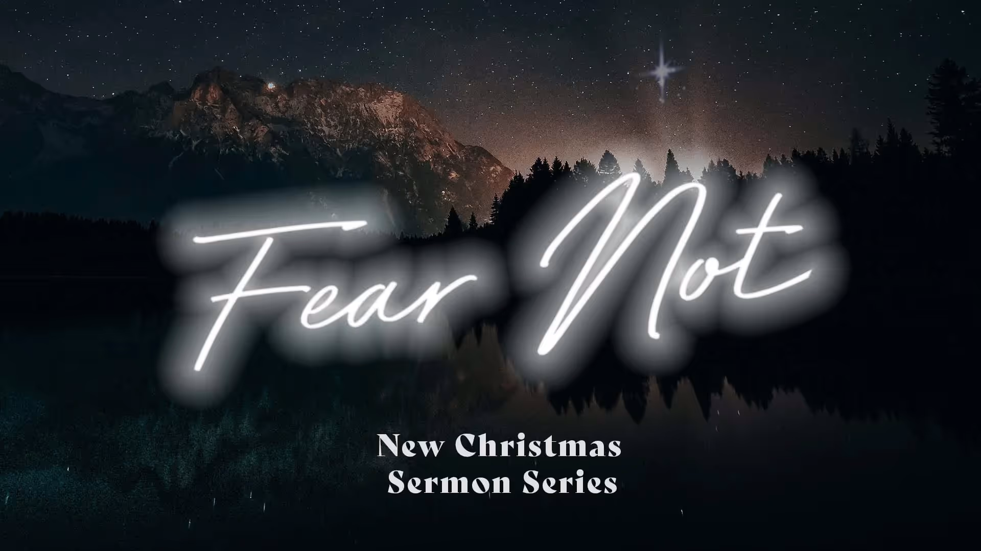 Neon "Fear Not" text over starry night mountain landscape, Christmas sermon.
