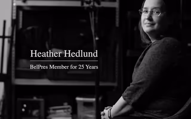 A black and white image of a women with glasses.