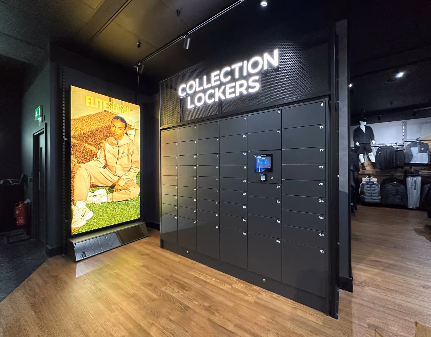 Modern collection lockers with digital screen inside a retail store with wooden floor and clothing display.