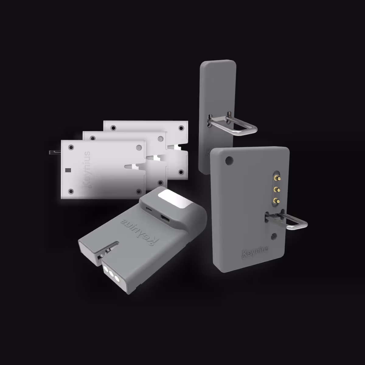 Gray Keymius smart lock components including battery pack, latch mechanisms, and mounting plates on black background.