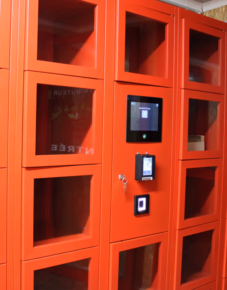 Red vending machine with multiple transparent compartments and a digital touchscreen interface.