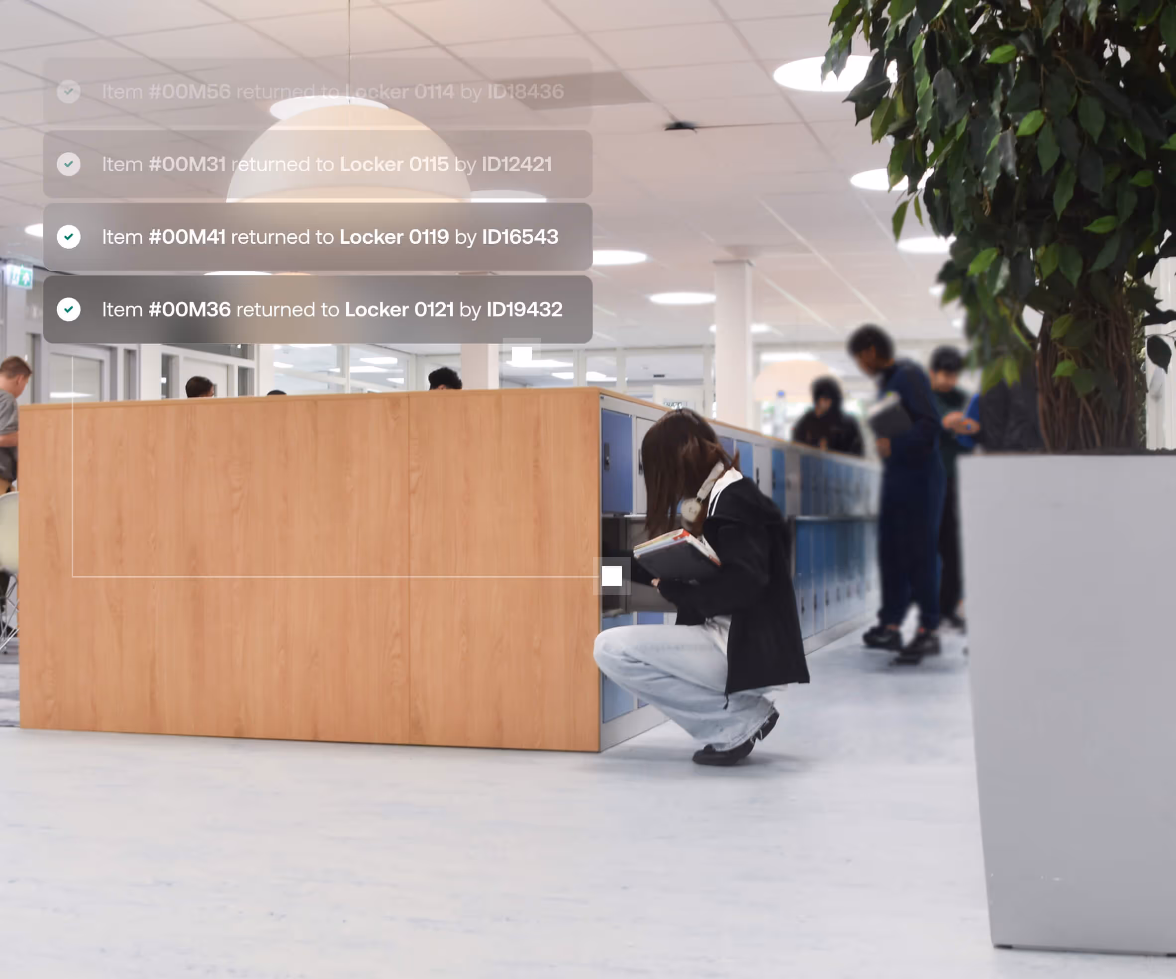 People in a modern indoor setting using blue lockers, one person crouching while holding books and interacting with a locker.