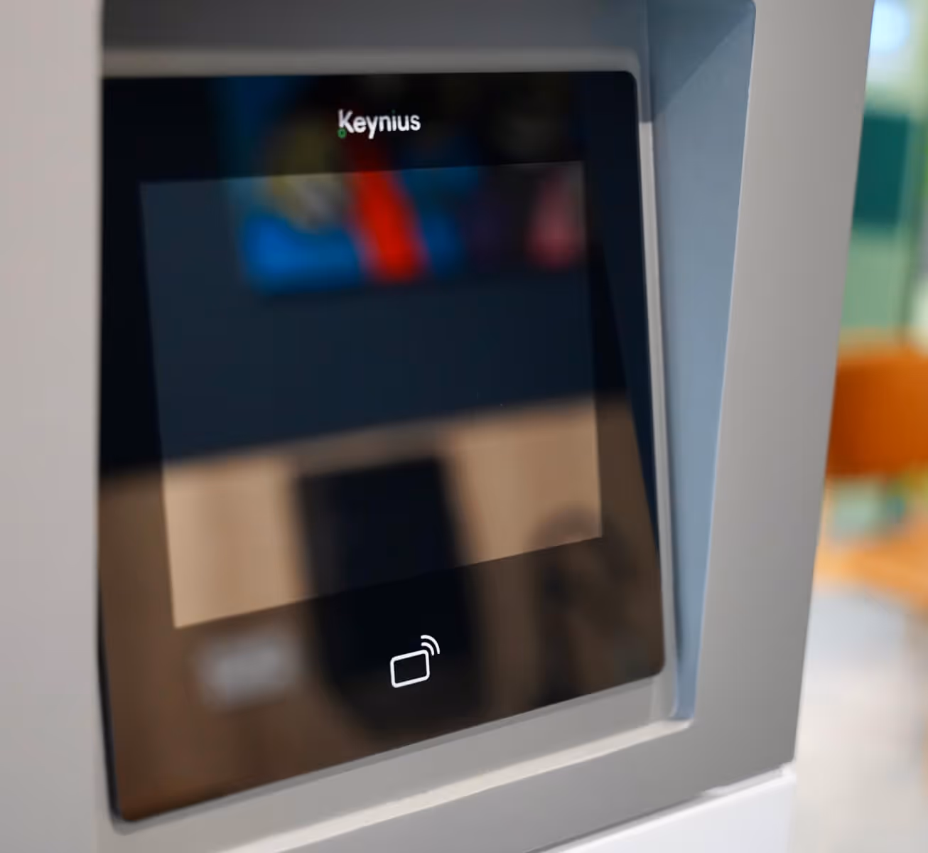Close-up of a Keynius branded touchscreen with a contactless card payment icon.
