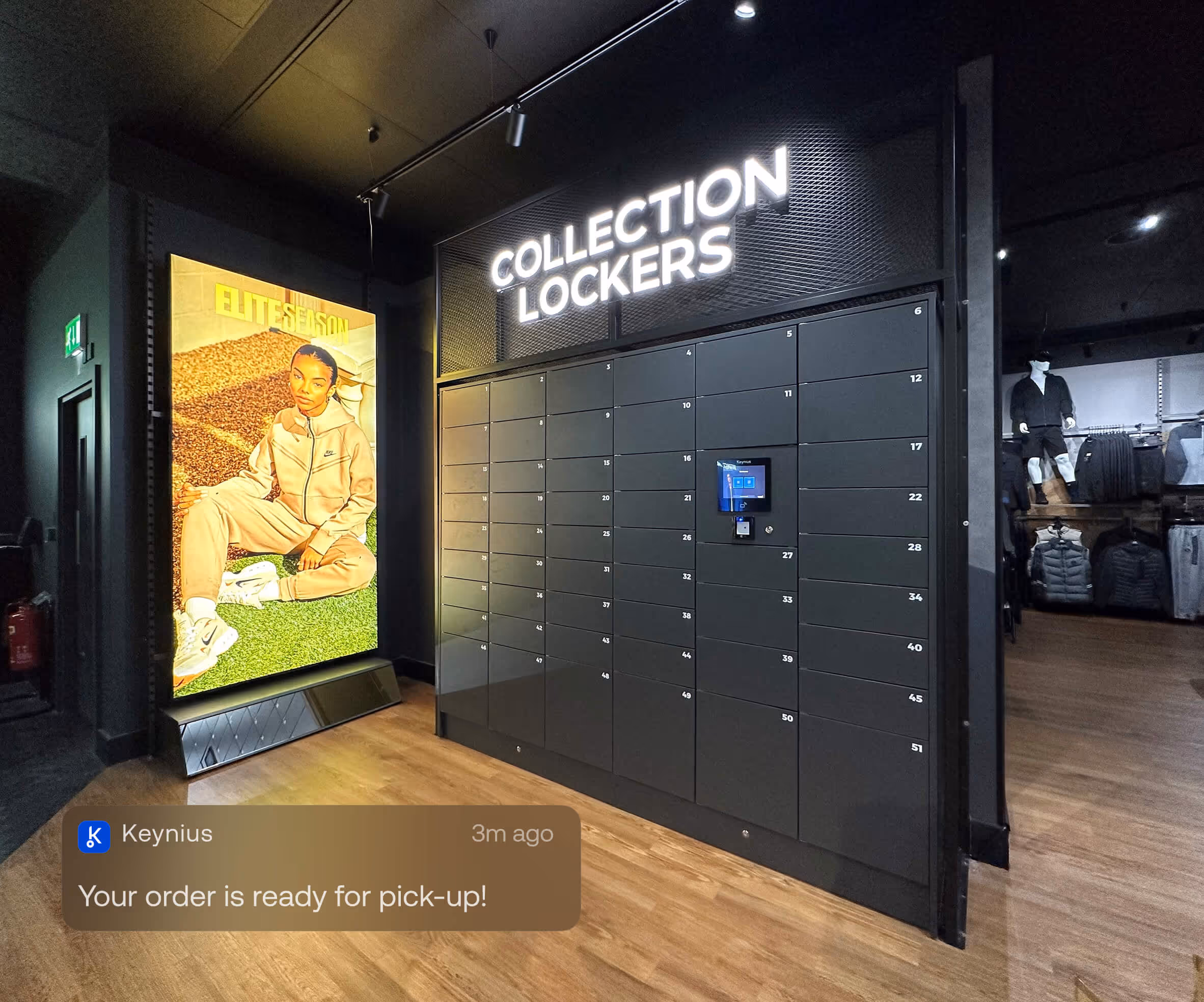 Modern retail space with black collection lockers under a lit sign and a large poster of a person in beige sportswear seated on green grass.