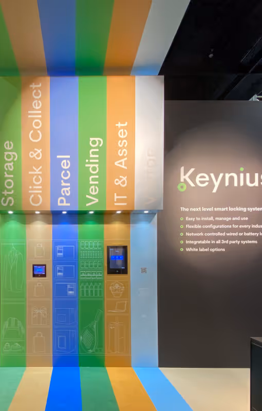 Smart locker system with colored vertical panels labeled Storage, Click & Collect, Parcel, Vending, and IT & Asset, next to a wall with Keynius branding and features list.