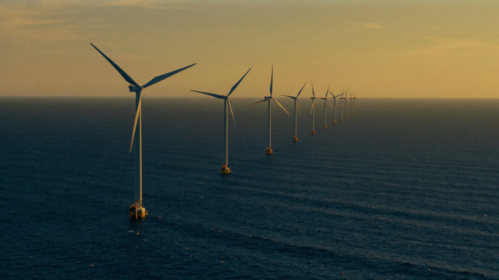 Windmolens op zee bij zonsondergang