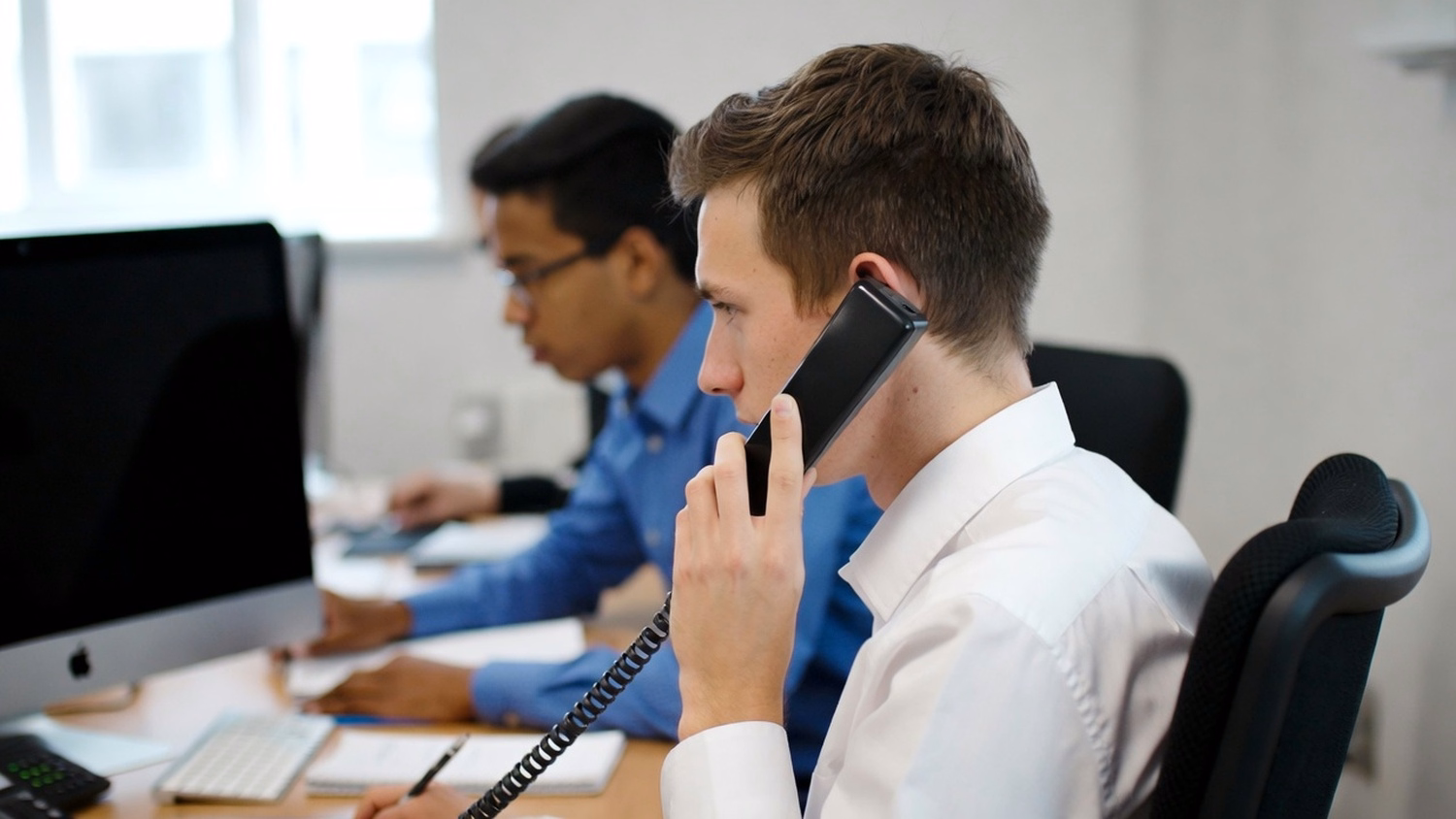 [('PHONE CALL AT DESK', 'one person at a desk with phone to one ear,