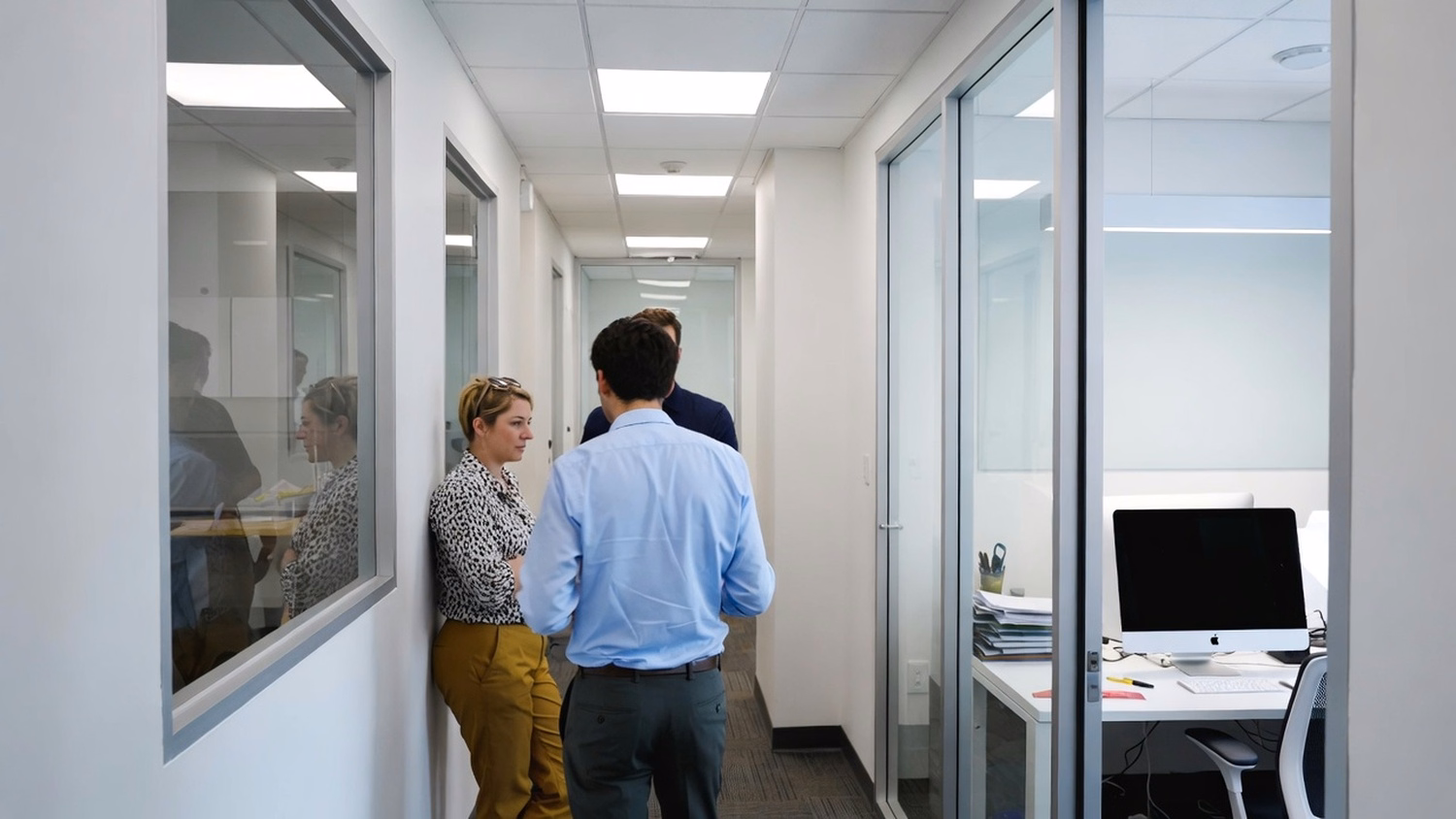 [('INFORMAL HUDDLE', 'two people standing and talking near a kitchen