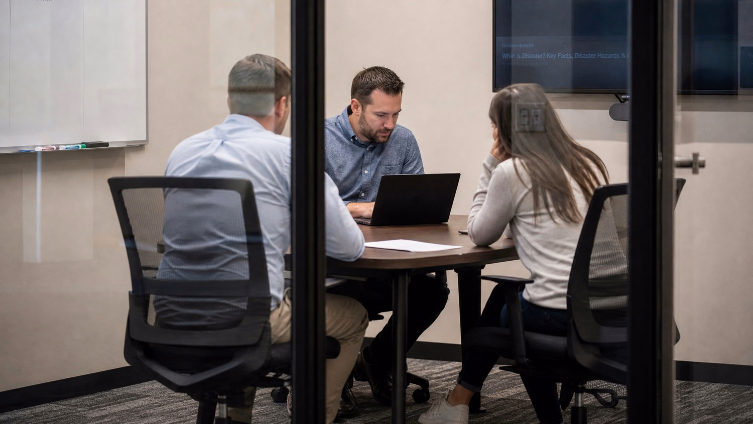 [('SMALL CONFERENCE ROOM', 'three people seated around a small table