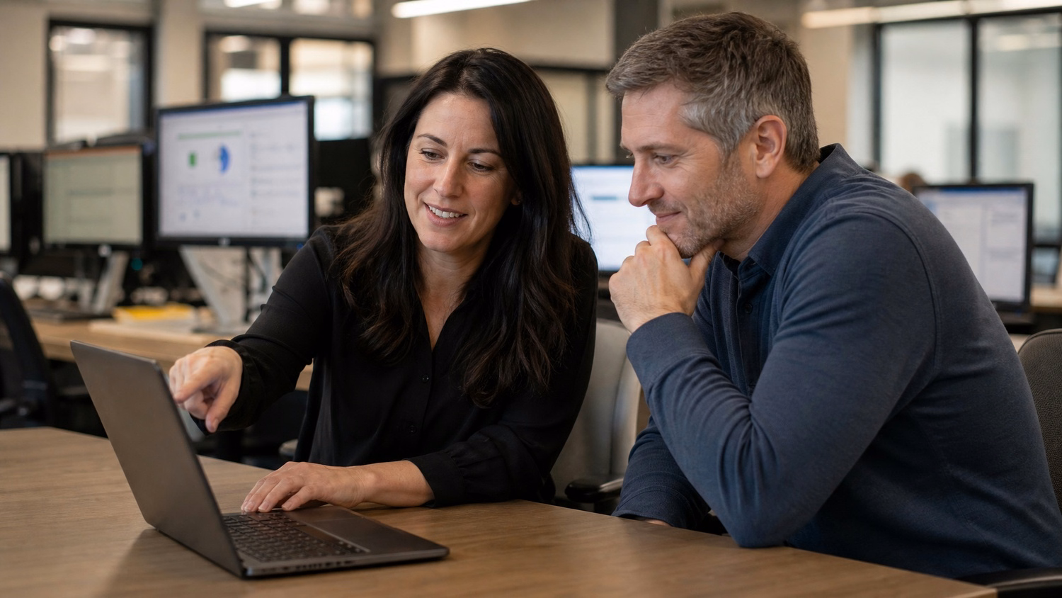 Tech professionals review AWS migration plan on laptop