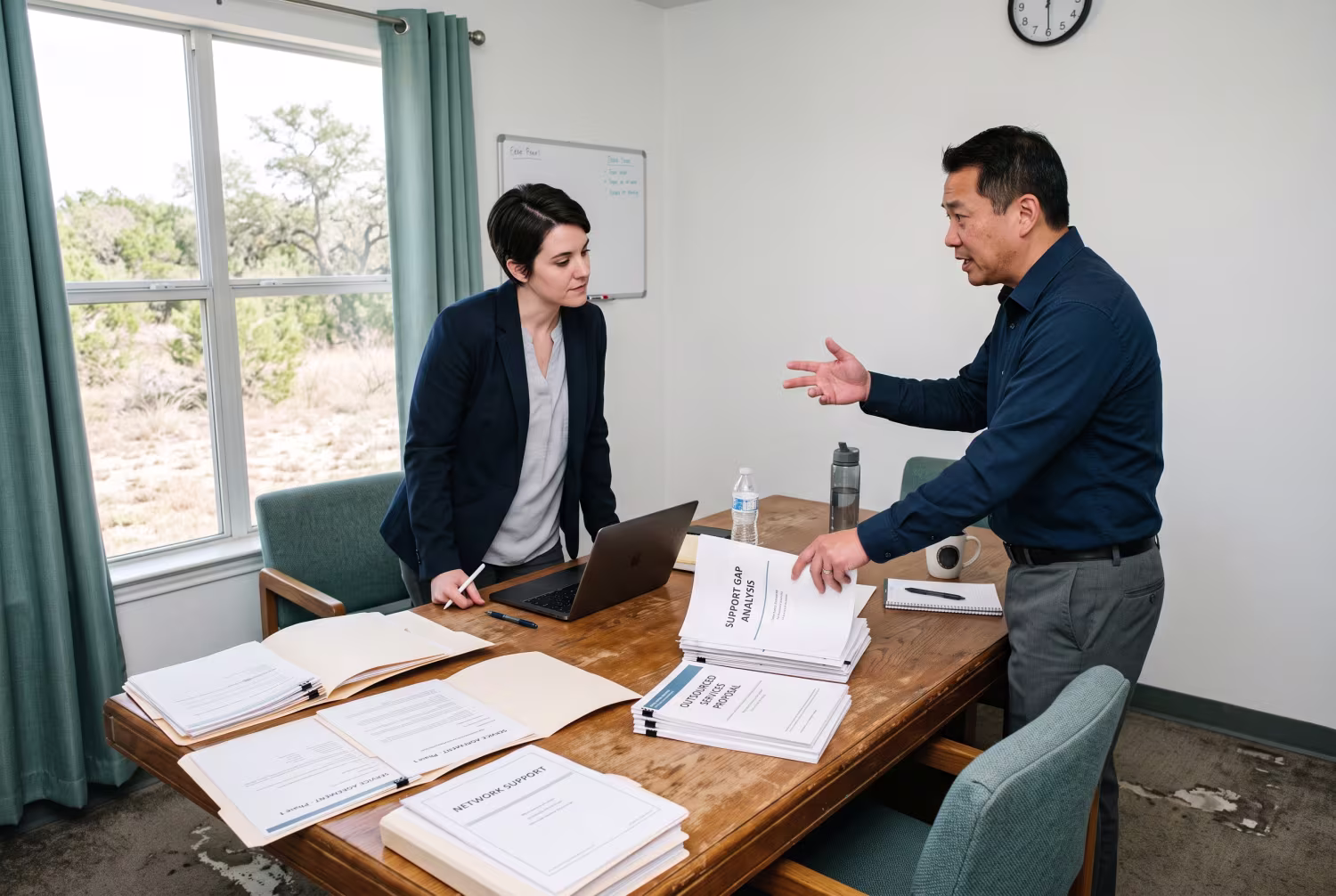 IT consultant discussing potential outsourced services with manager