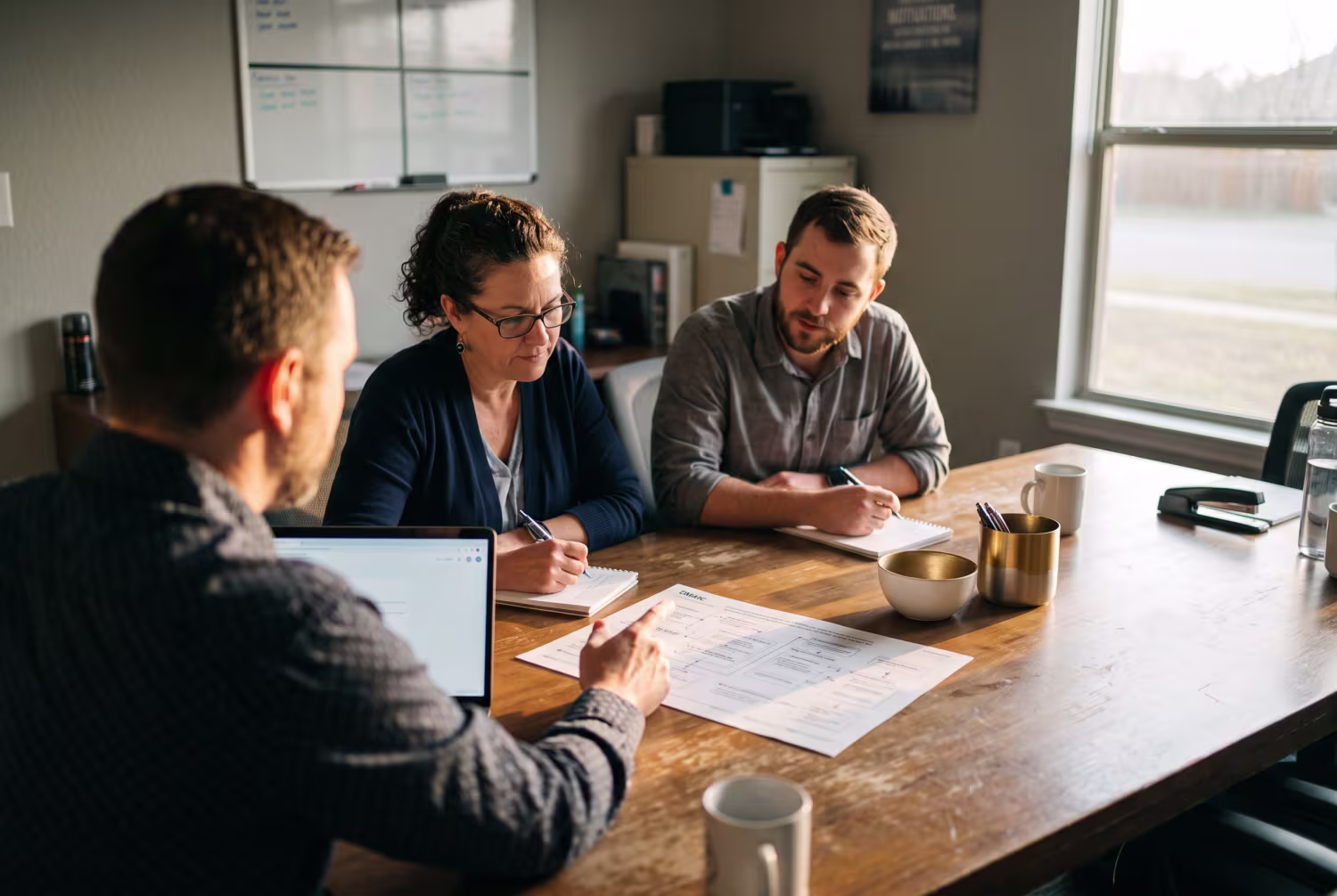 IT consultant discussing DMARC settings with employees in office