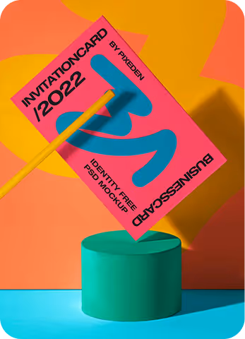 Bright pink invitation card with bold blue 'B' held by a yellow stick above a green cylindrical pedestal, set against an orange and yellow abstract background.