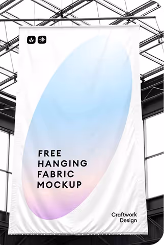 White hanging fabric banner with a soft pastel gradient and text reading 'Free Hanging Fabric Mockup' and 'Craftwork Design' set against a modern industrial ceiling backdrop.