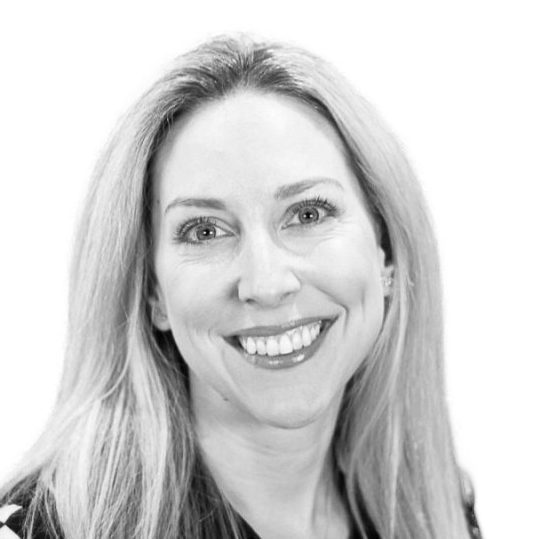 Smiling female team member at Revenue Nomad, contributing to sales and revenue growth strategies for B2B organizations.