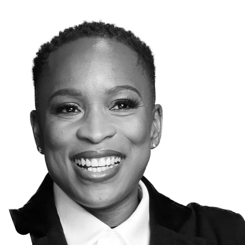 Smiling female executive in a professional setting, representing leadership and talent development, aligned with Revenue Nomad’s mission of empowering sales and RevOps teams.