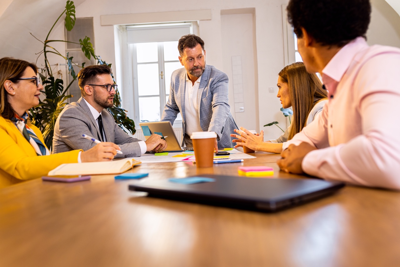 Business team evaluating sales strategies and discussing the benefits of fractional sales leadership.