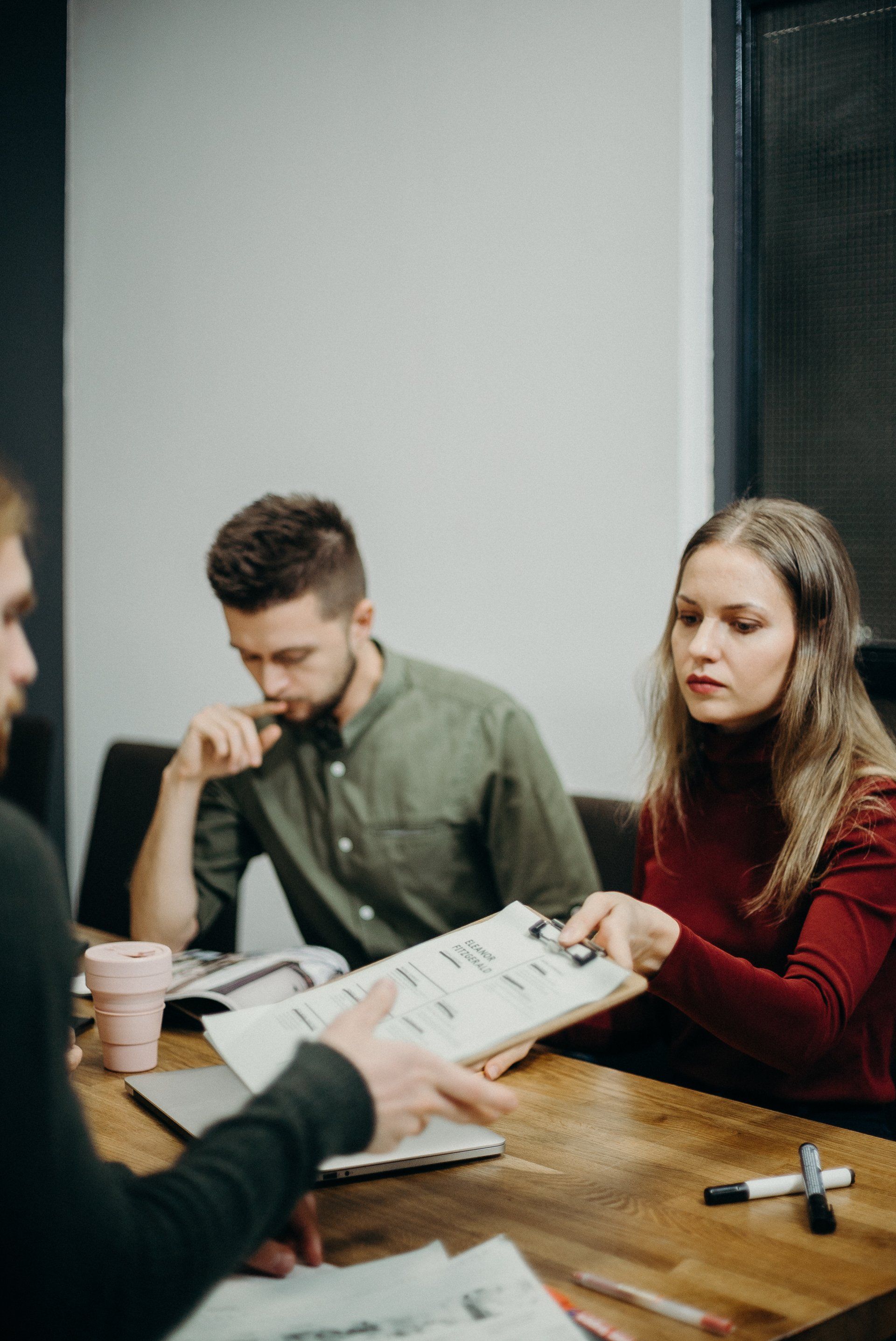 A hiring team evaluating a potential sales leader's qualifications during a structured interview process.