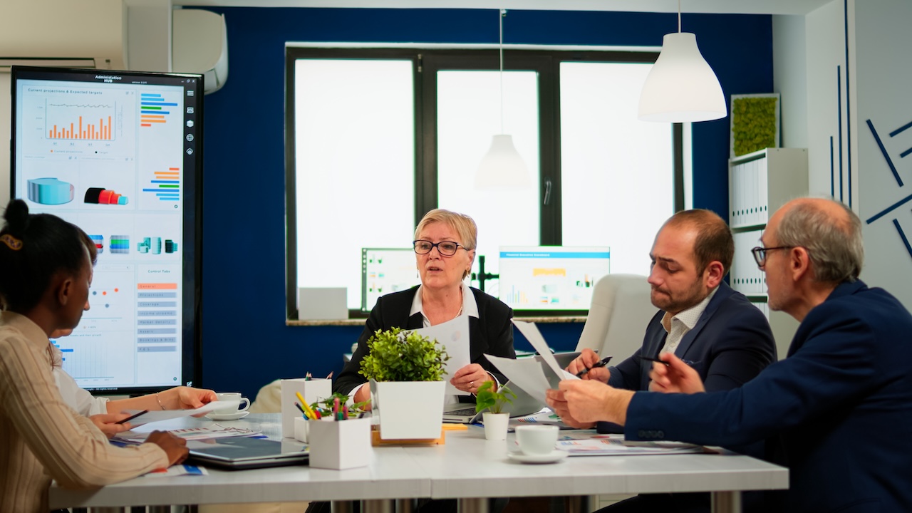 Revenue operations leader guiding a diverse team through performance metrics and strategic initiatives.