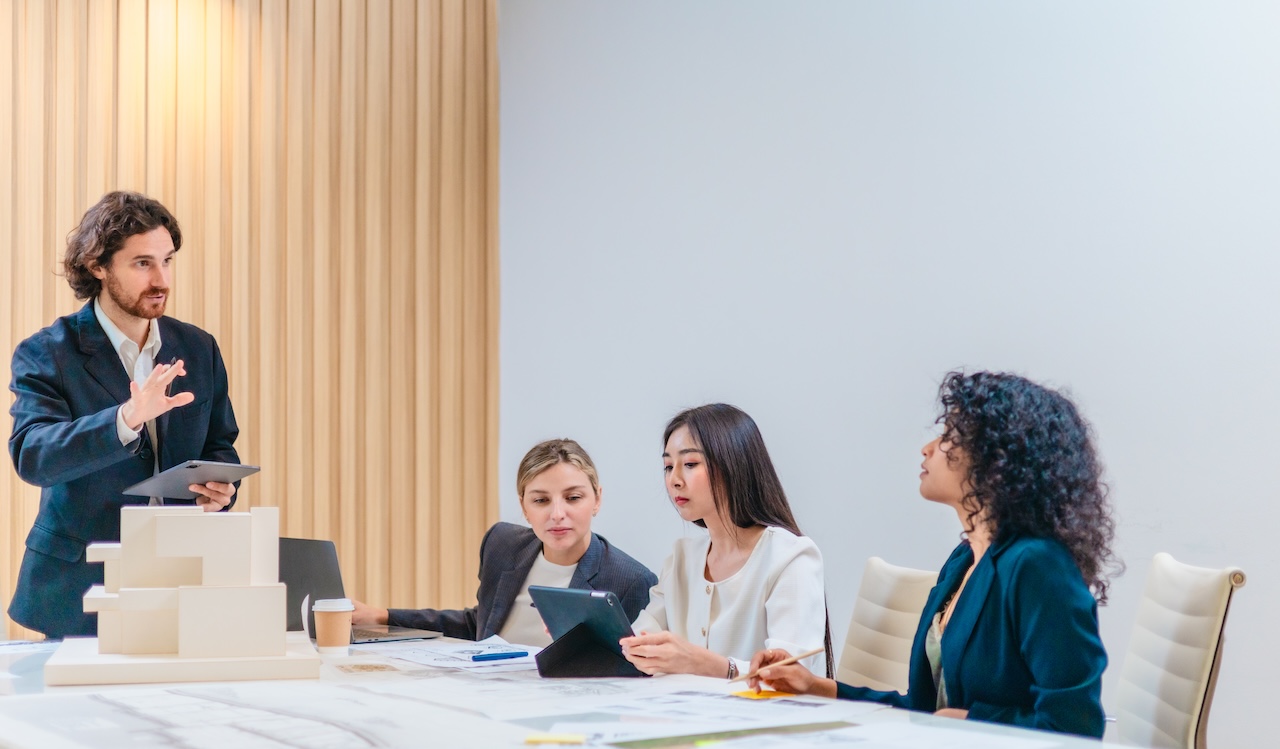 Fractional leadership team brainstorming project ideas and implementing revenue growth strategies in a modern office.