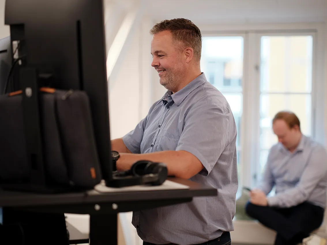 Man with a coffee cup in an office.