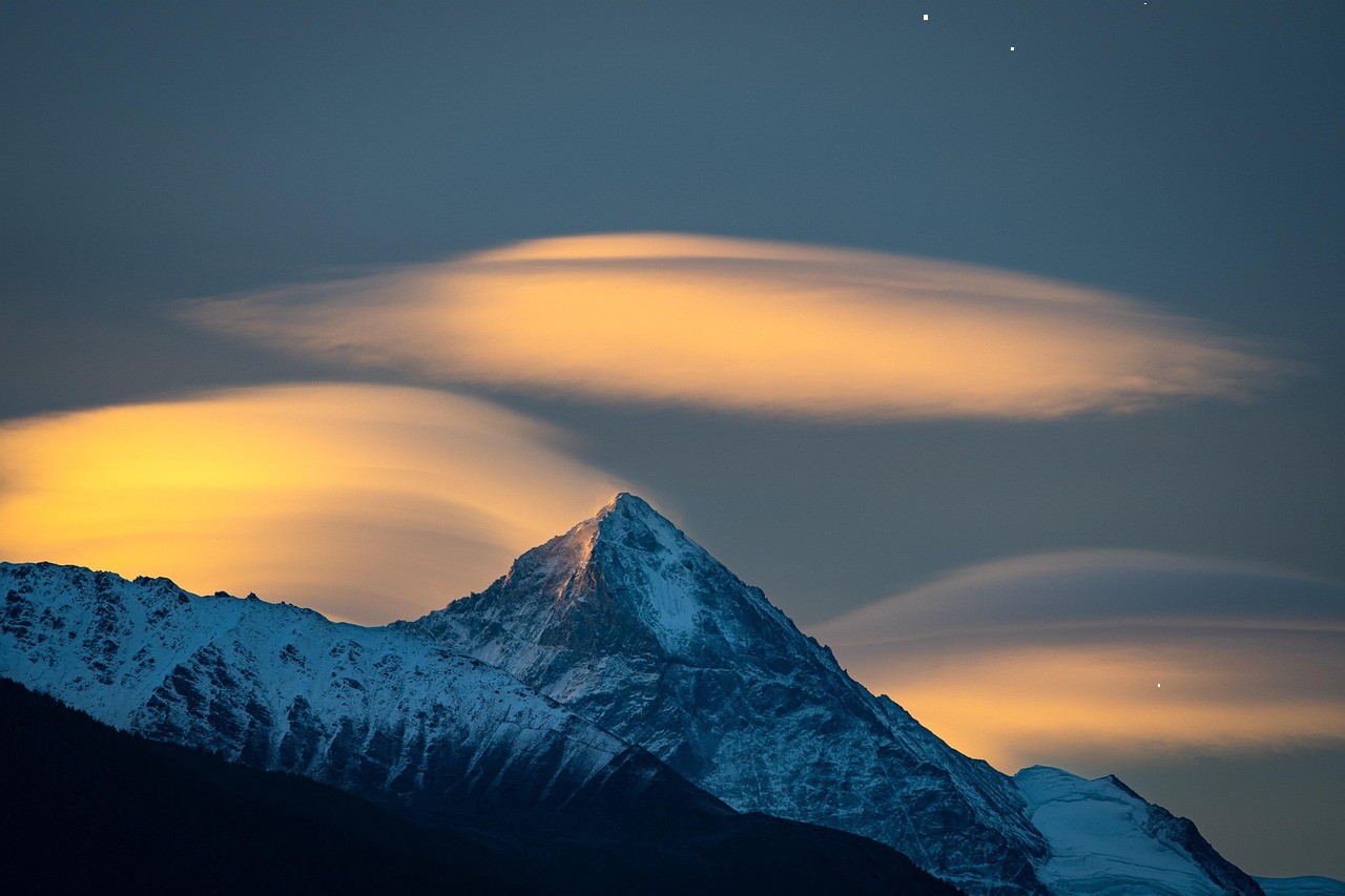 A snow-covered mountain beneath an evening sky.