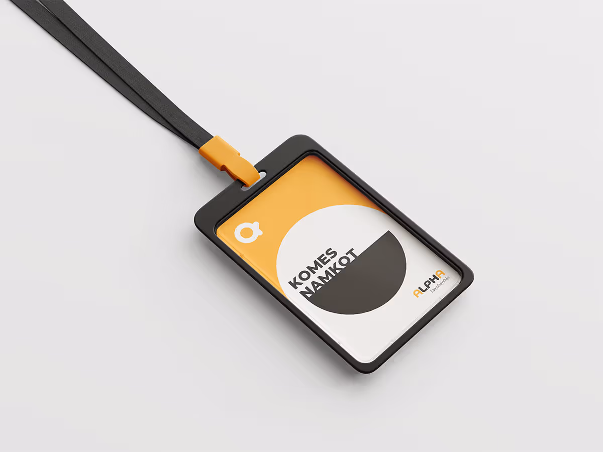 Black lanyard with a modern ID badge in a black holder. The badge has an orange and white design with geometric shapes and "Alpha" logo, emitting a sleek, professional vibe.