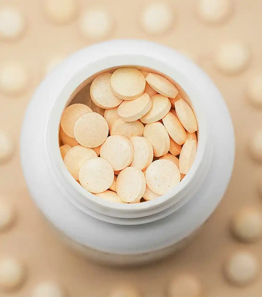 A  bottle of gel capsules on its side, with the contents spilling out