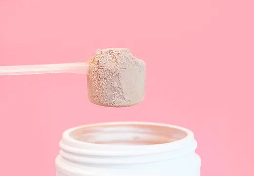 A scoop is nestled in a pile of effera™ powder.