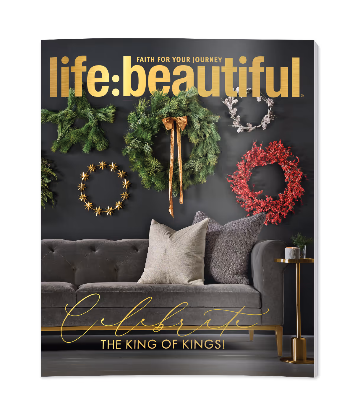 Cover of Life:Beautiful magazine with Christmas wreaths on a black wall above a gray sofa with two pillows and a gold side table with a candle.