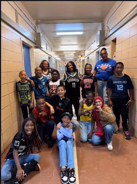 Students and staff posing together in a school hallway