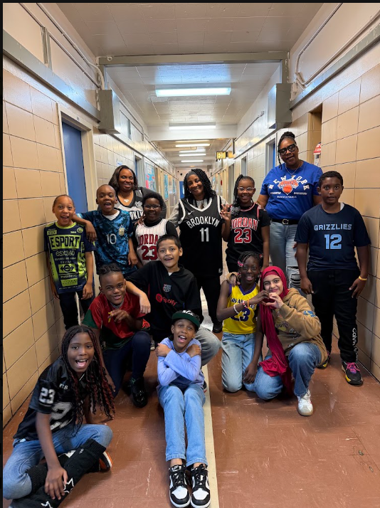 Students and staff posing together in a school hallway