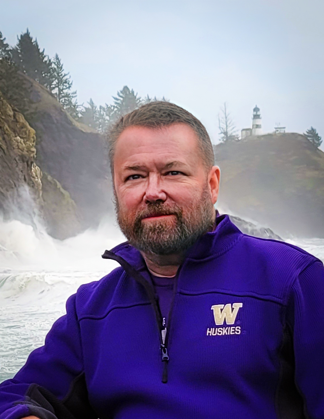 Builder with purple sweatshirt and University of Washington logo on left breast area