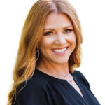 redheaded women with long hair and black shirt