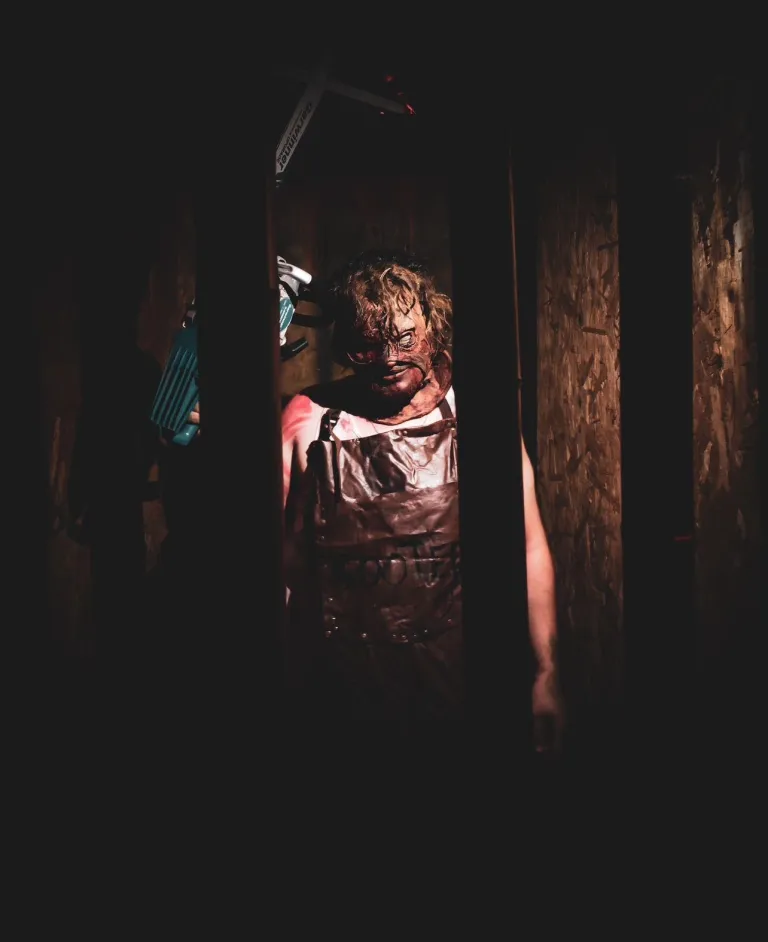 A man is standing in a dark room.