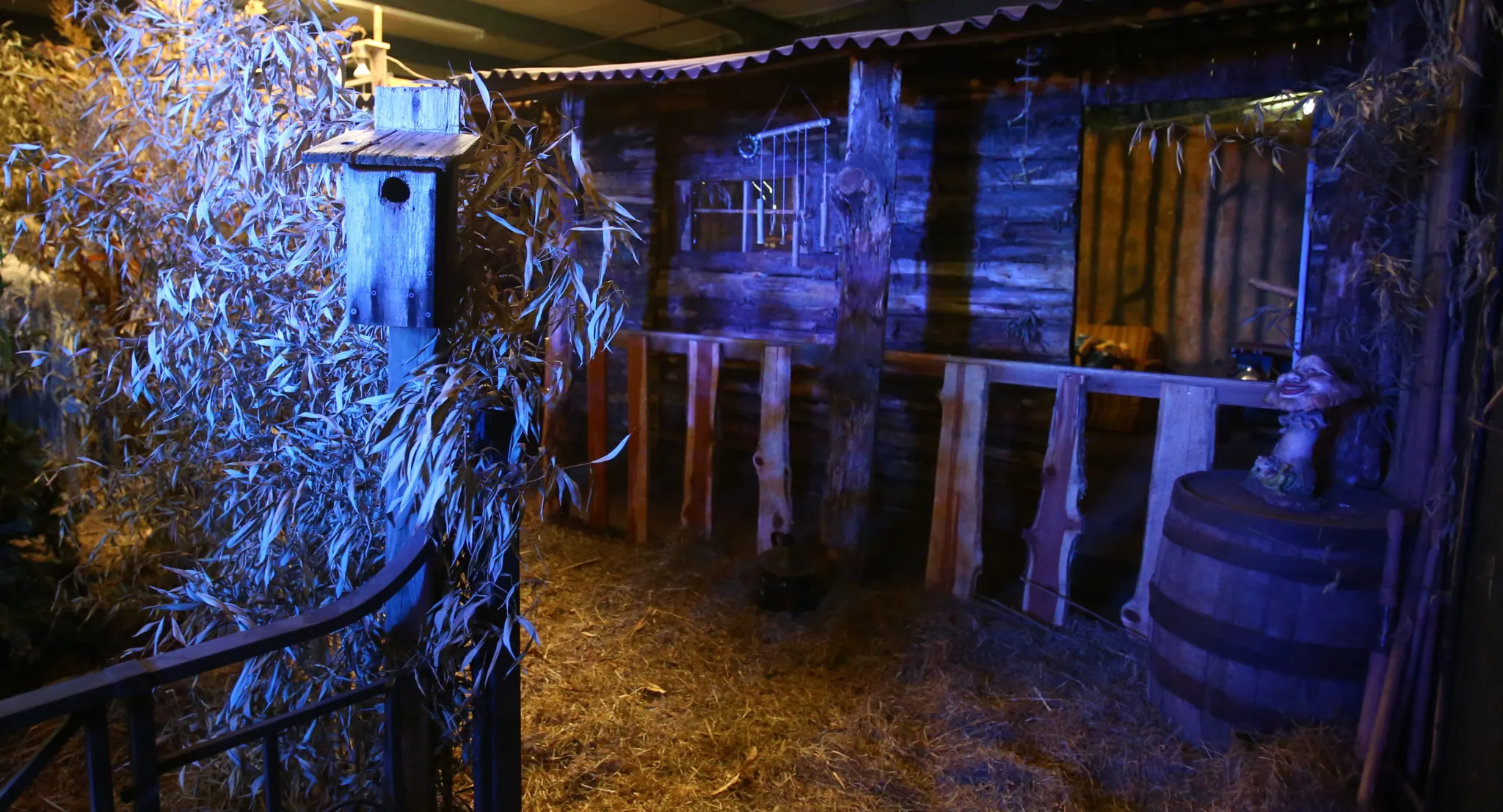 A barn with a bunch of hay inside of it.