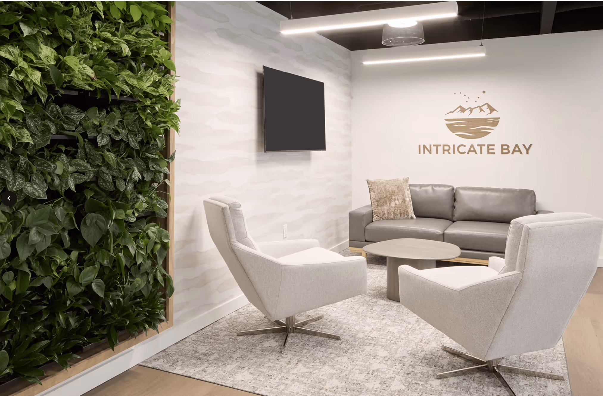 A living room with a couch and two chairs.