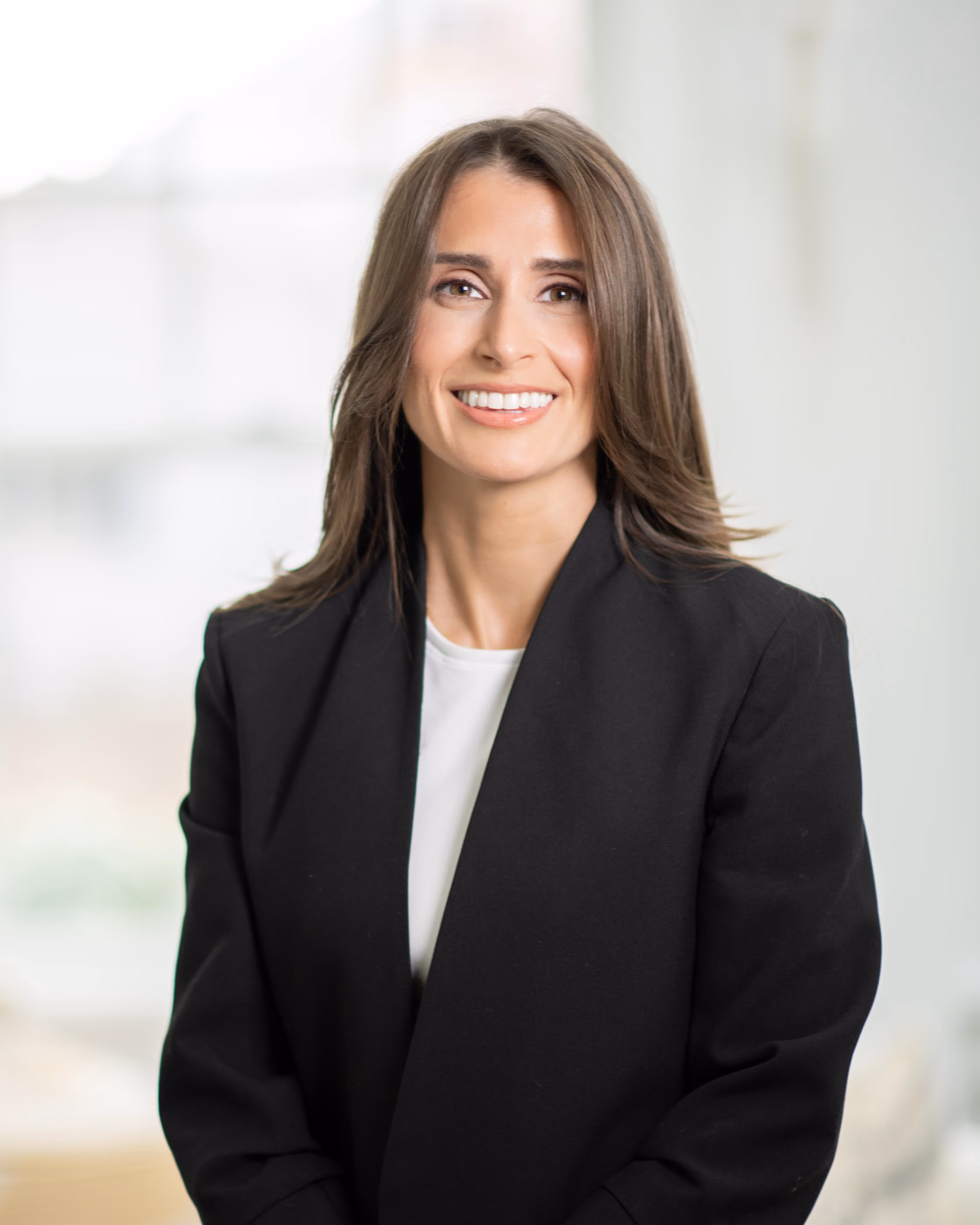A woman in a black jacket and white shirt.