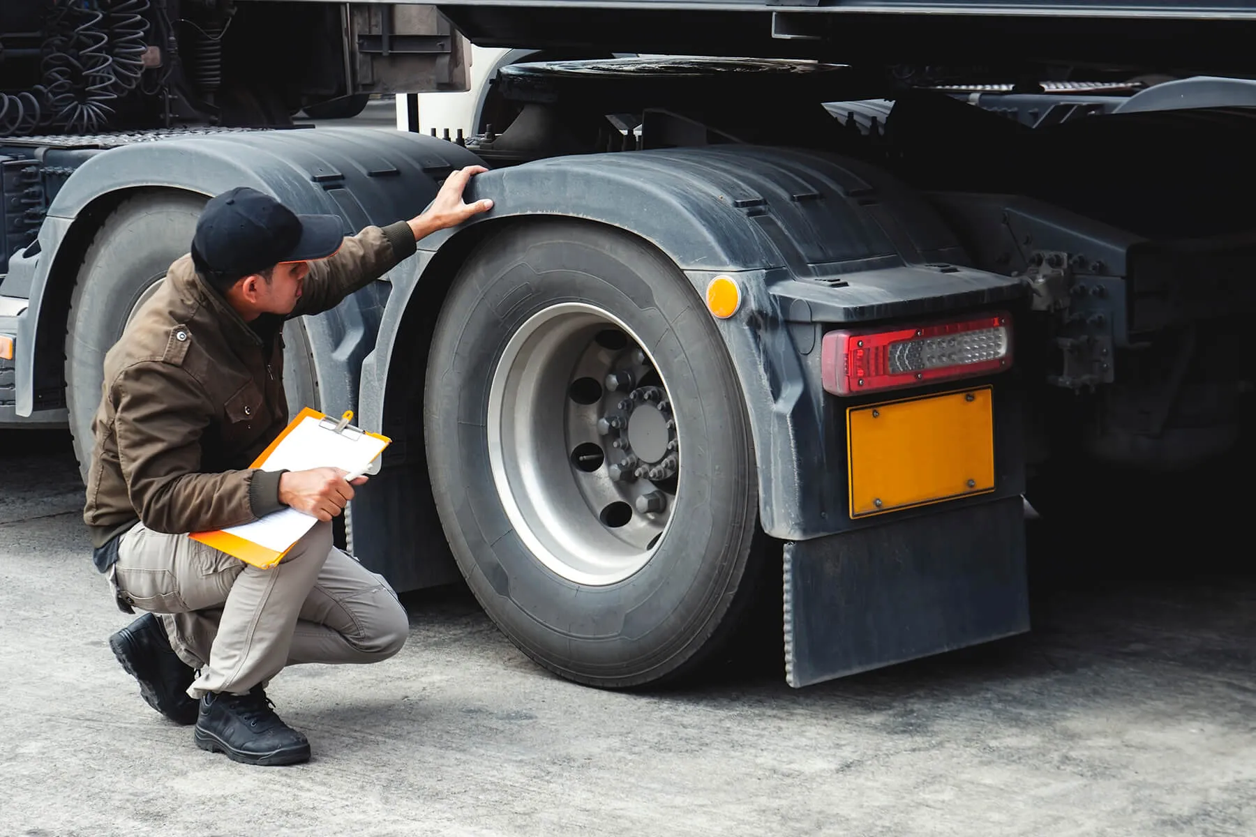 Driver inspecting safety of trailer before the ride