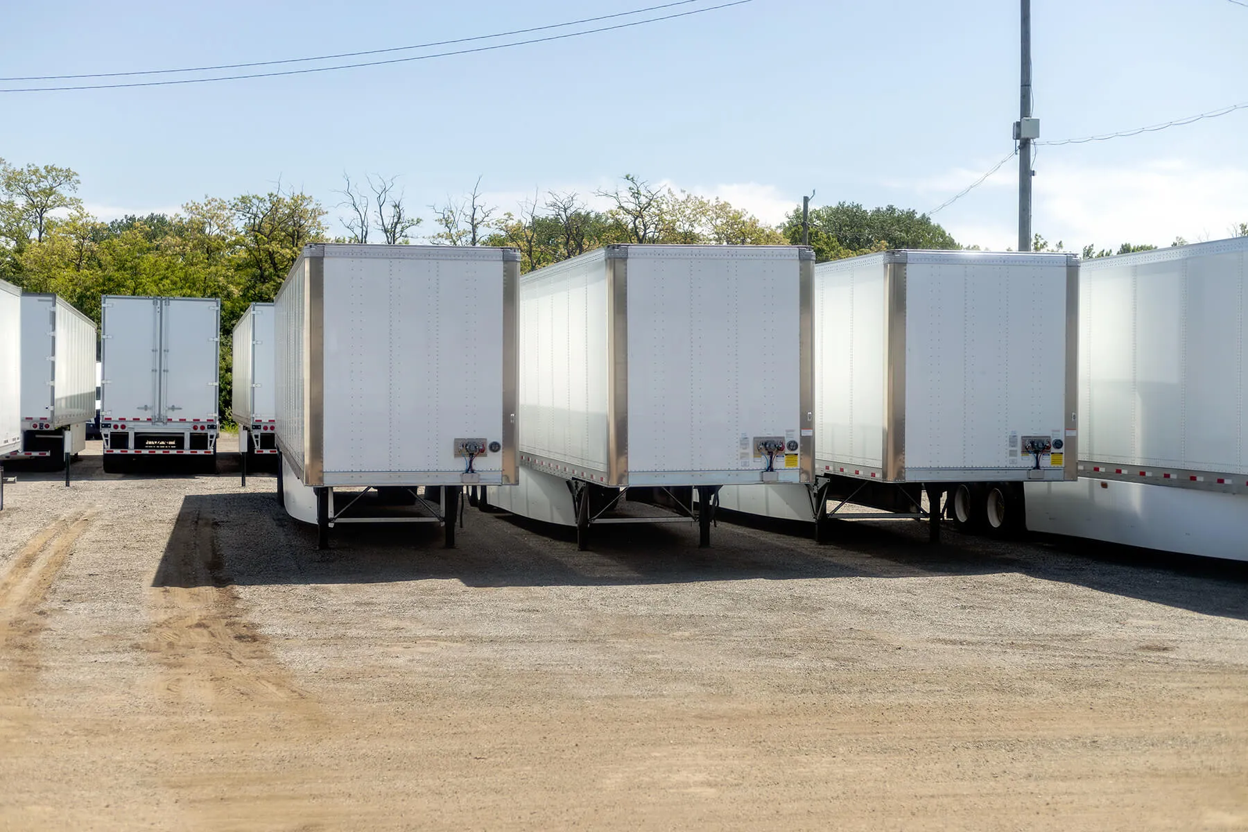 Rows of trailers sitting in a parking lot