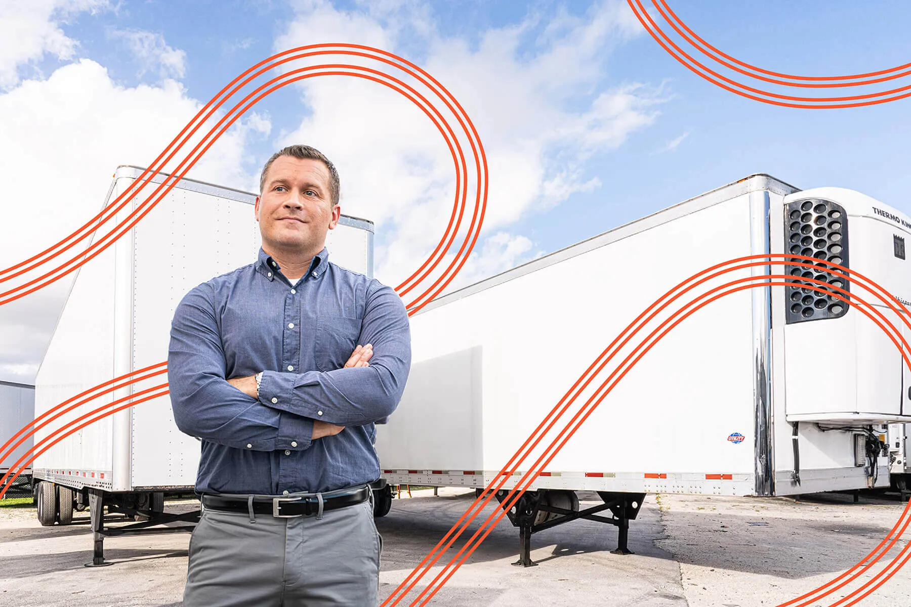 A man standing in front of large trailers
