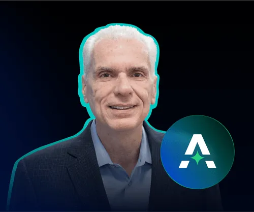 A man with white hair and a suit jacket.