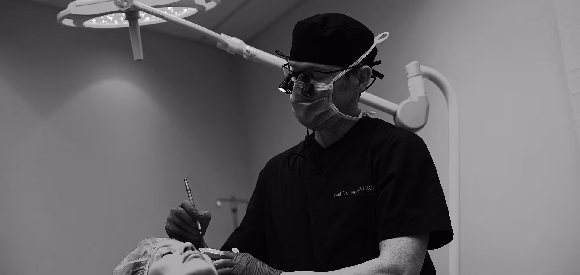 Image of Dr. Paul Denton located in Vancouver, BC doing an upper eyelid blepharoplasty surgery on a patient at Refine Cosmetic Surgery